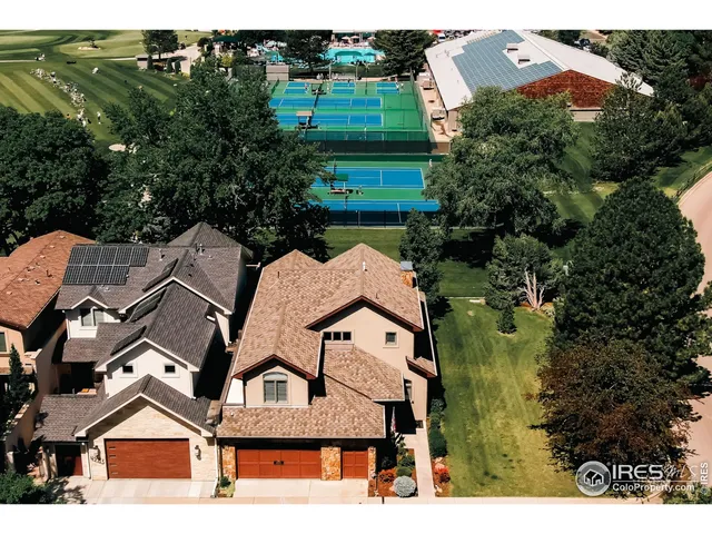 an aerial view of multiple houses with yard