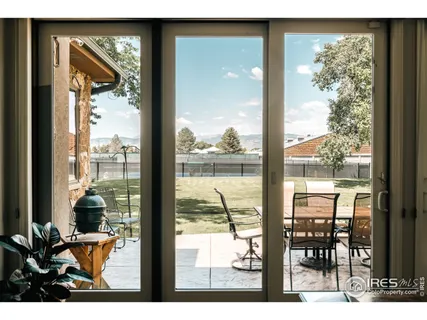 a view of a room with a large window and dining room
