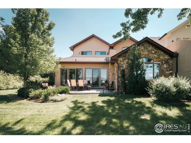 a backyard of a house with yard and outdoor seating