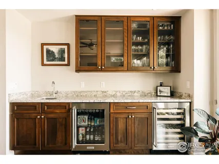a view of kitchen with granite countertop cabinets and wooden floor
