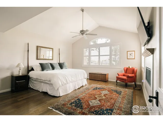 a spacious bedroom with a bed a couch and a window