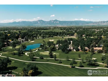 an aerial view of residential houses with outdoor space and lake view