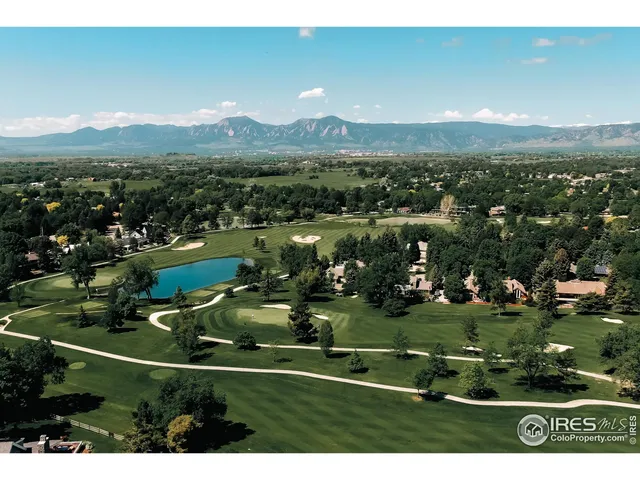an aerial view of residential houses with outdoor space and lake view