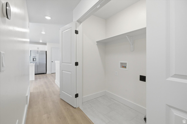 730 West 500 North Smithfield, UT 84335 - Photo 13 of 46 Dedicated laundry closet featuring a white shelf, tiled flooring, and hookups, with a wood-finish hallway and recessed lighting