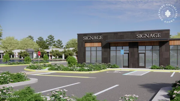 front view of a brick house with a yard