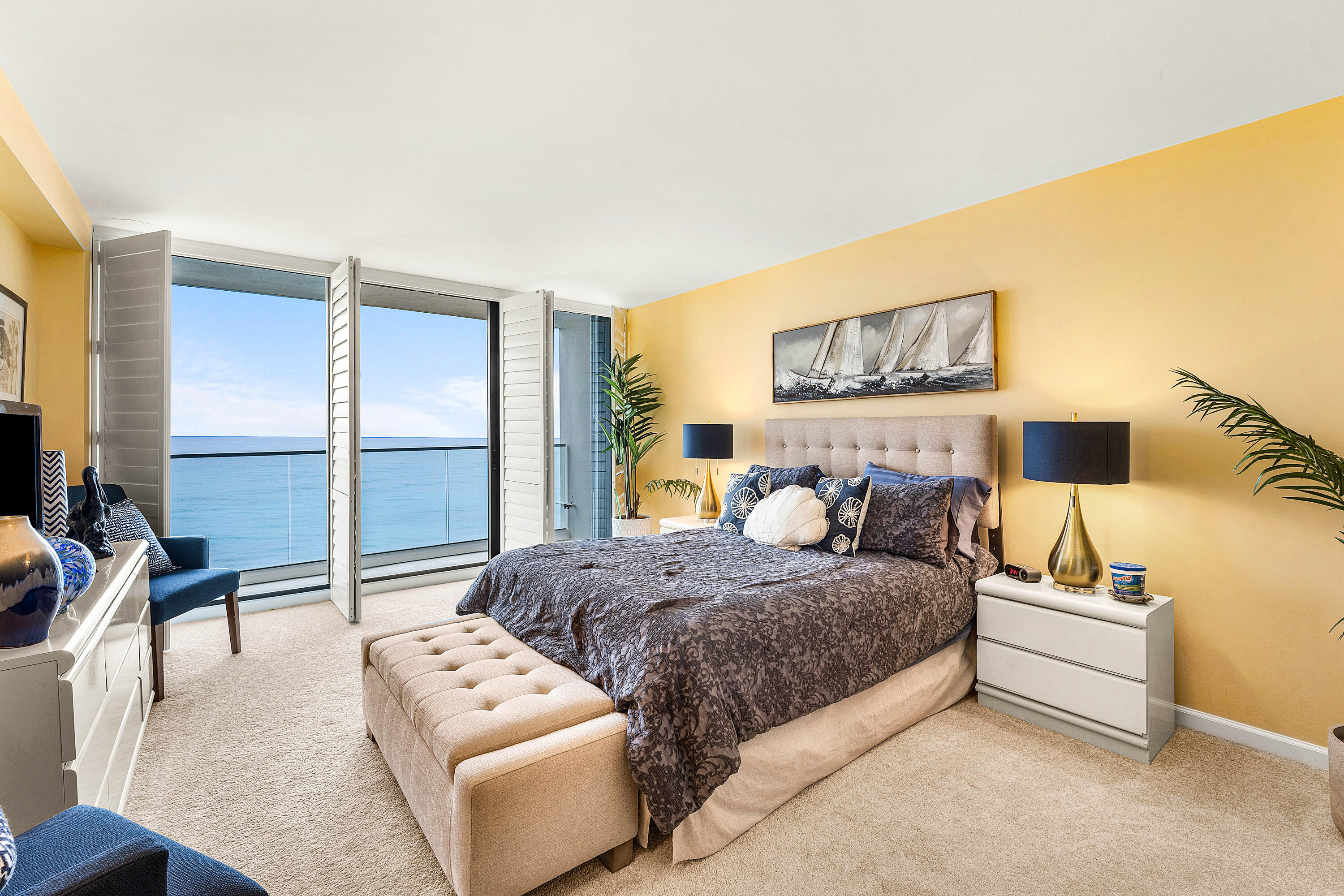 100 South Beach Road, Unit 602 Tequesta, FL 33469 - Photo 23 of 57 a bedroom with a bed a couch and a night stand