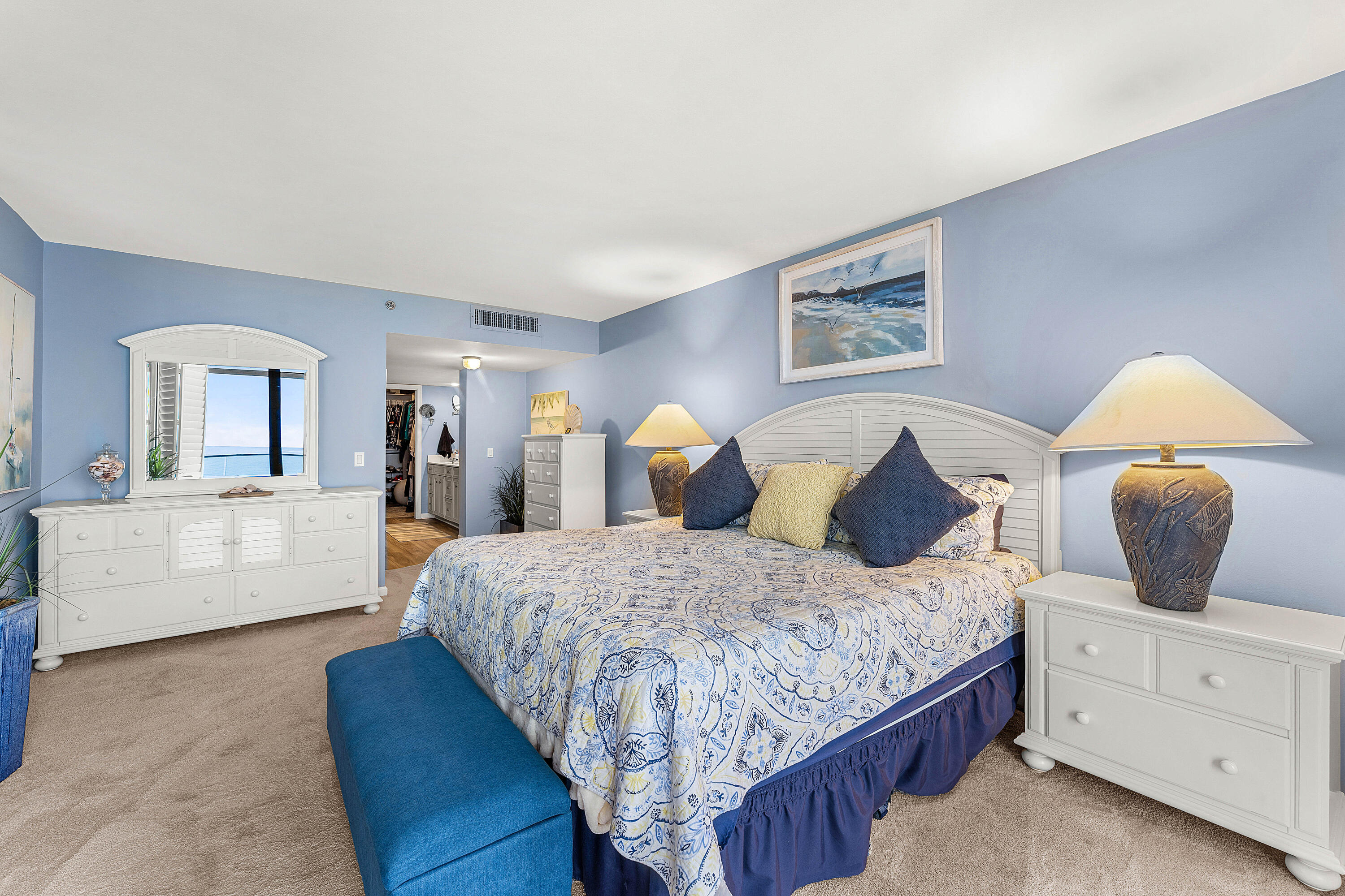 100 South Beach Road, Unit 602 Tequesta, FL 33469 - Photo 27 of 57 a bedroom with a large bed and a chandelier