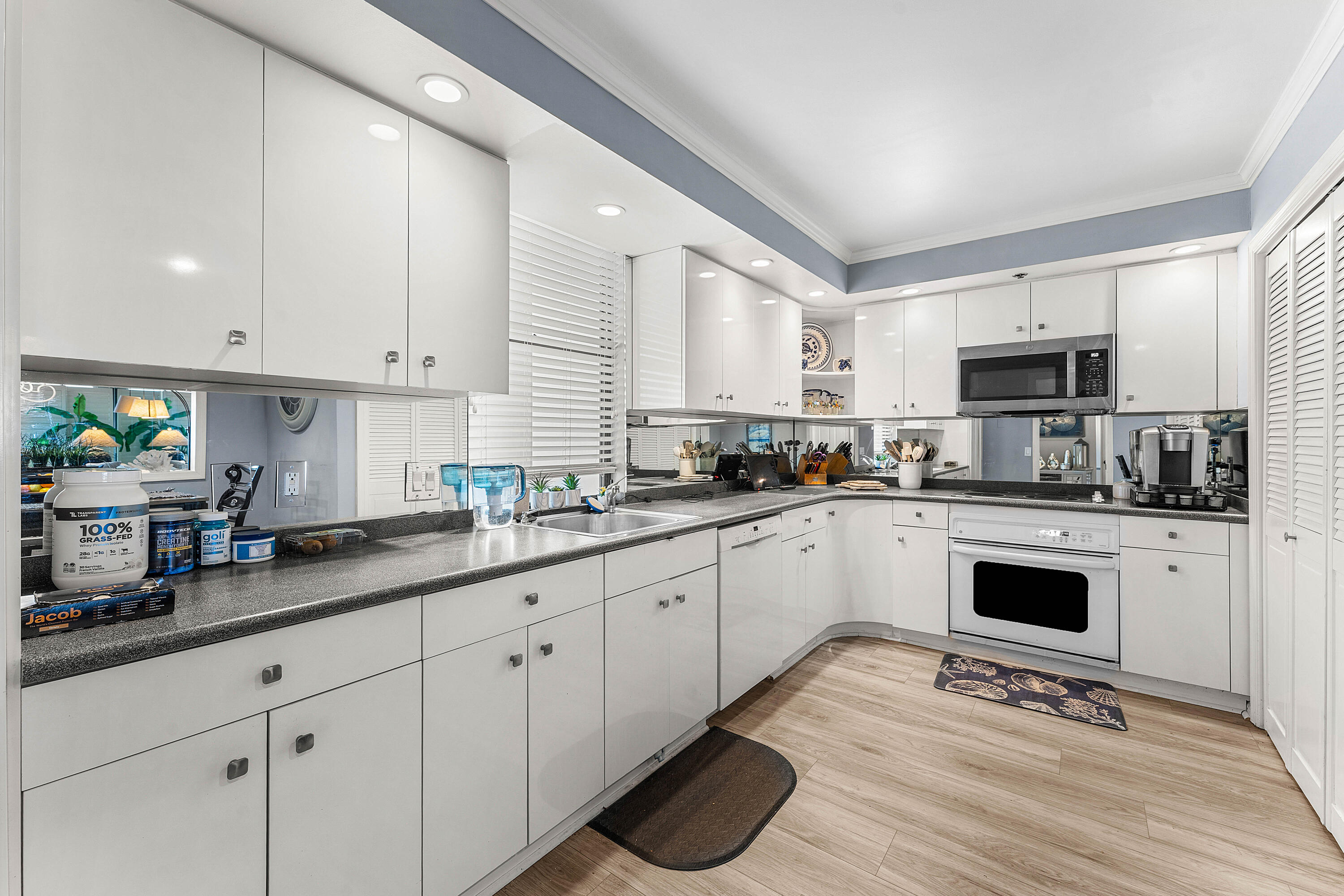 100 South Beach Road, Unit 602 Tequesta, FL 33469 - Photo 6 of 57 a kitchen with granite countertop white cabinets and white appliances