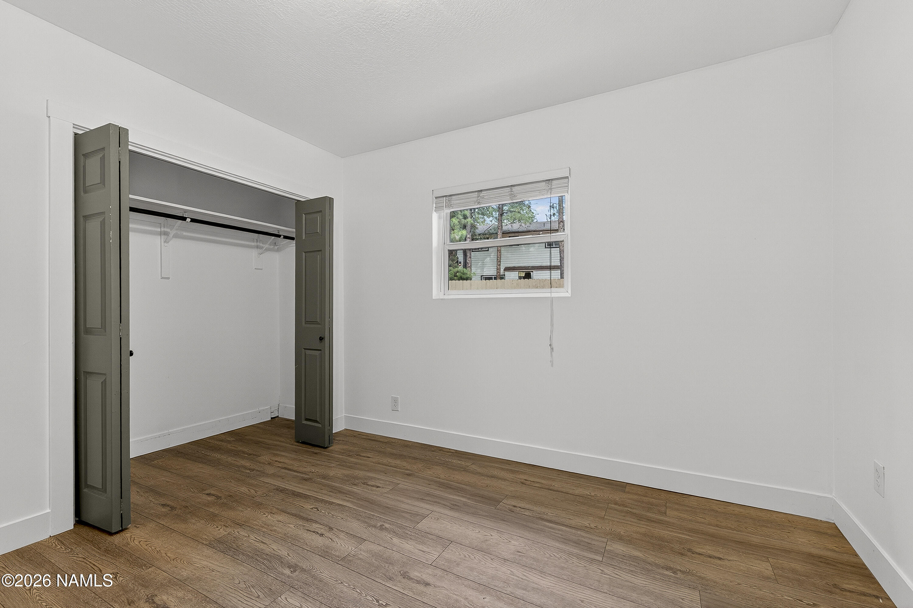 530 East Charles Road Flagstaff, AZ 86001 - Photo 15 of 54 an empty room with wooden floor and closet