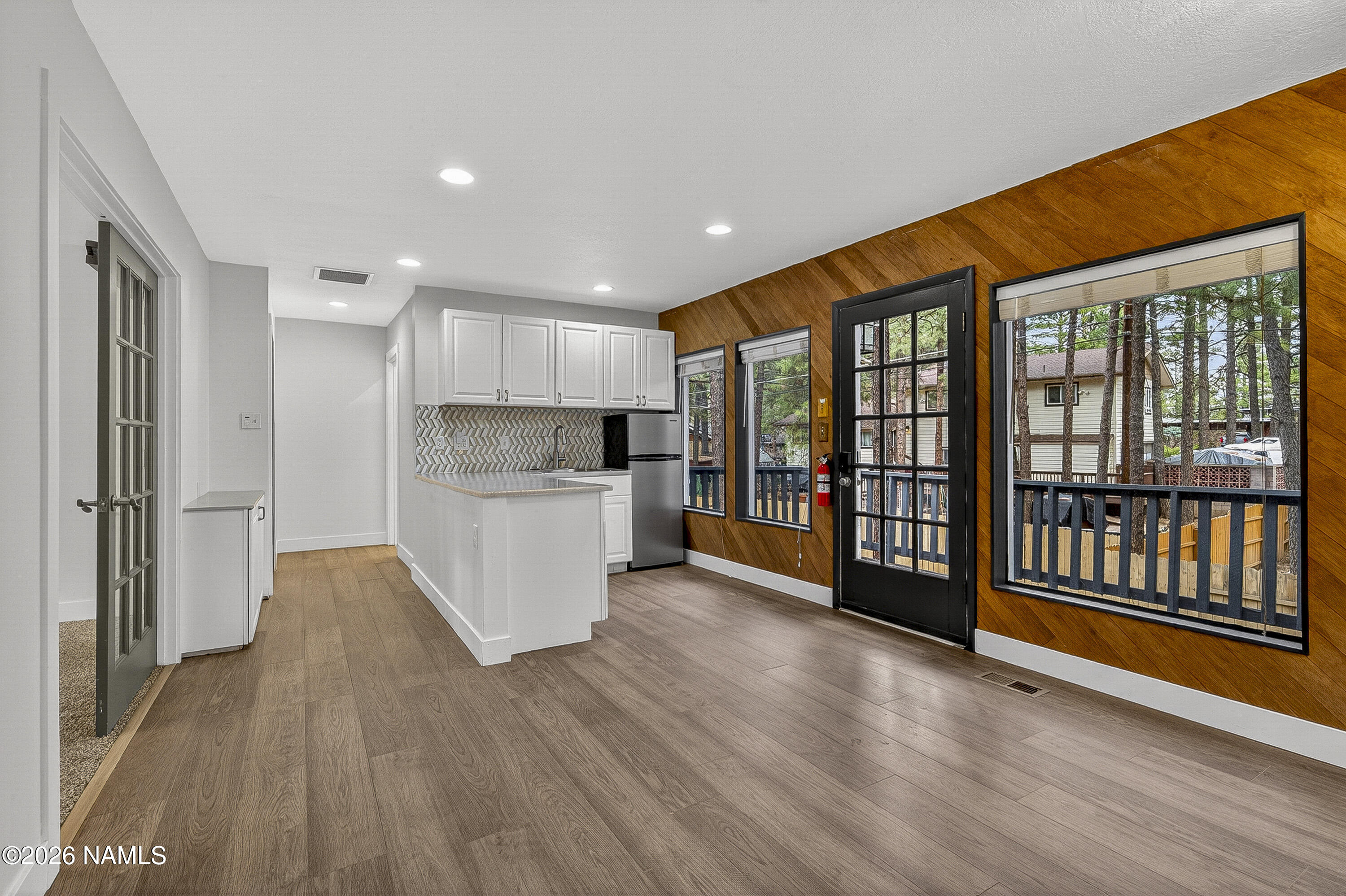 530 East Charles Road Flagstaff, AZ 86001 - Photo 34 of 54 a view of a kitchen with stainless steel appliances wooden floor and a large window
