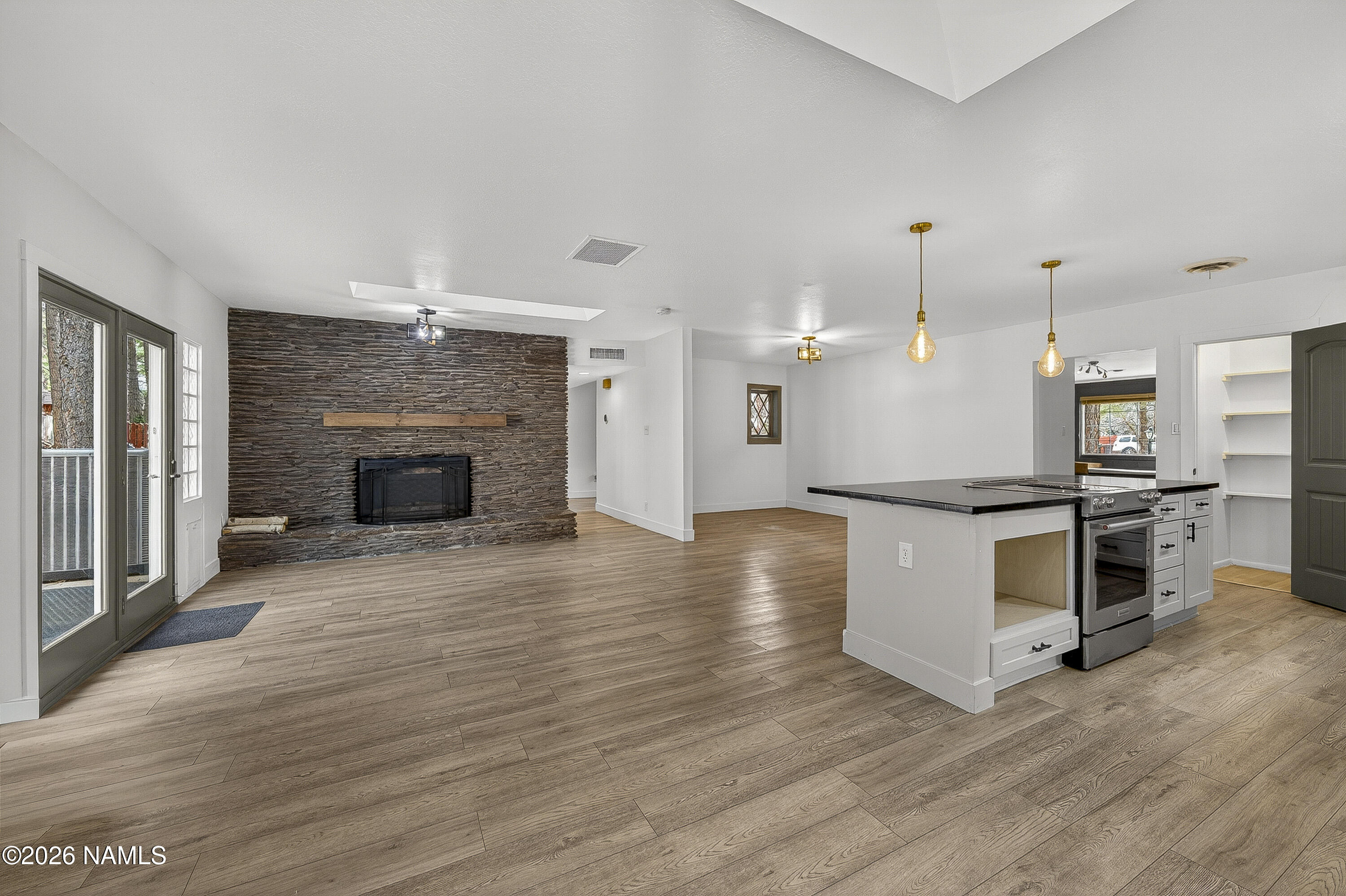 530 East Charles Road Flagstaff, AZ 86001 - Photo 10 of 54 a view of kitchen and kitchen with furniture wooden floor and fireplace