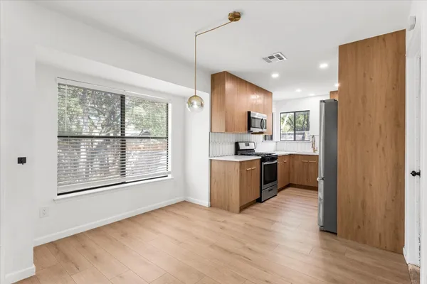 a view of a kitchen with a sink and a large window