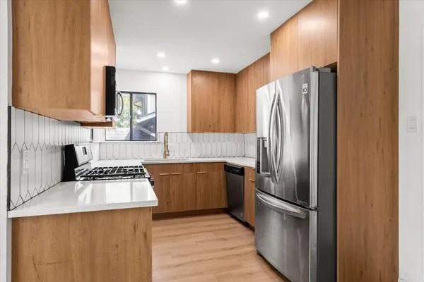 a kitchen with a refrigerator sink and stove