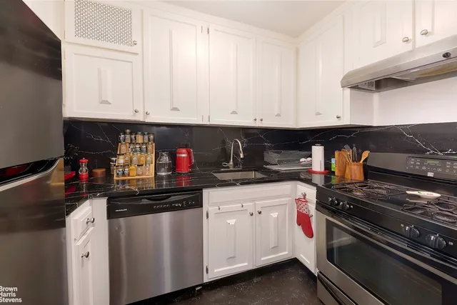 a kitchen with stainless steel appliances granite countertop a sink and cabinets