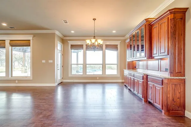 a open kitchen with stainless steel appliances granite countertop a stove a sink dishwasher window and cabinets