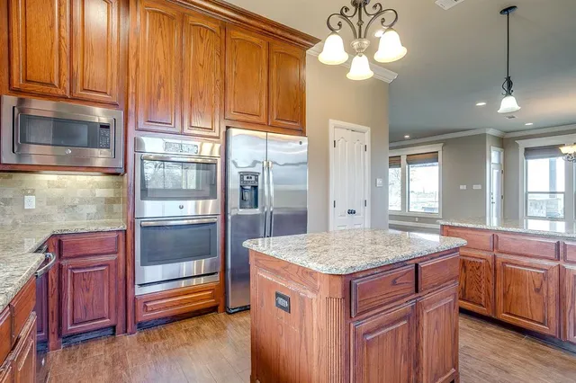 a kitchen with a sink and chandelier