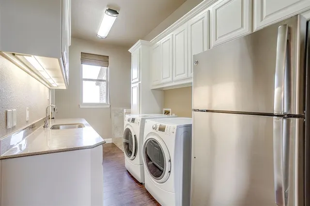 a kitchen with stainless steel appliances a refrigerator sink and cabinets