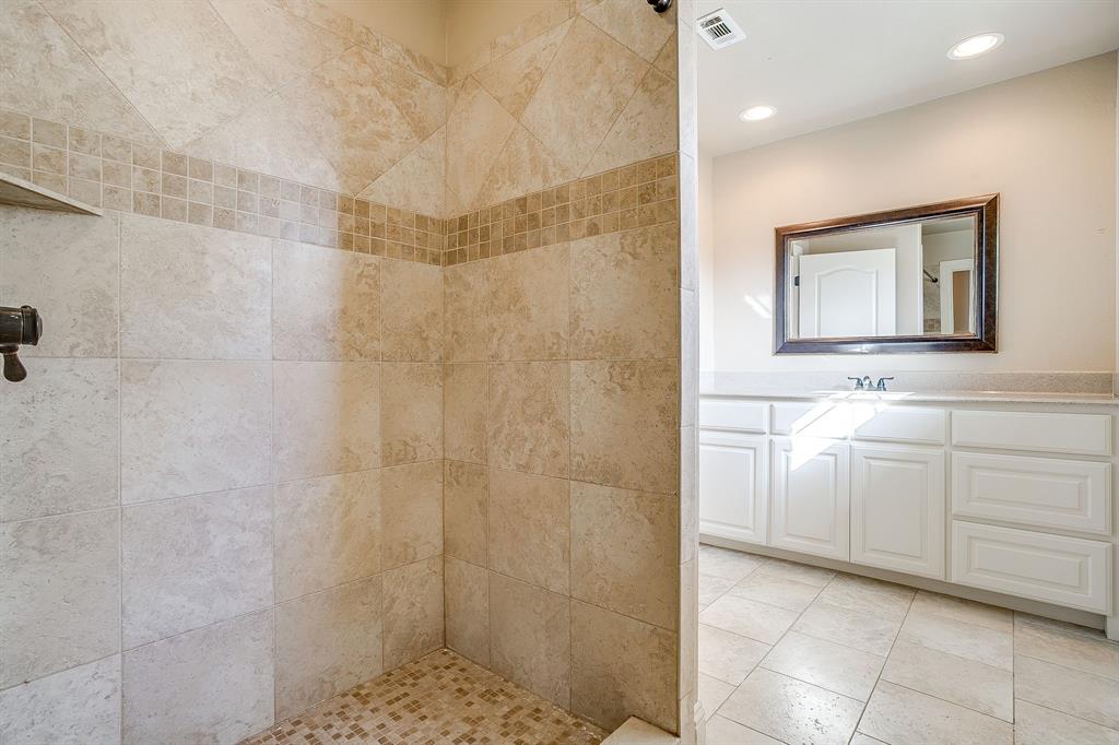 1600 Oak Ridge Estates Weatherford, TX 76085 - Photo 26 of 40 a bathroom with a sink a toilet and a mirror