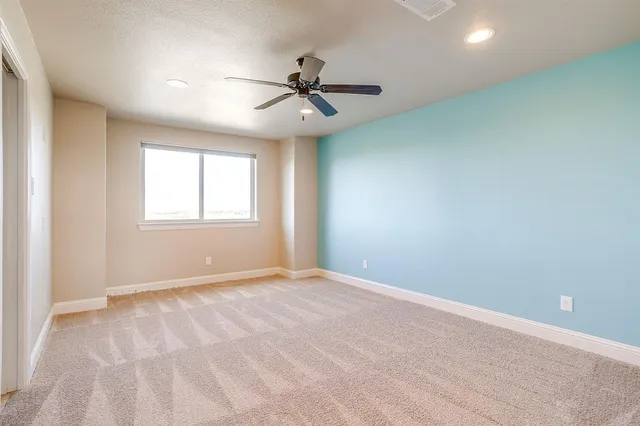 a view of a livingroom with a ceiling fan and window