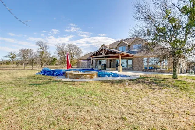 a roof deck with a table and chairs under an umbrella