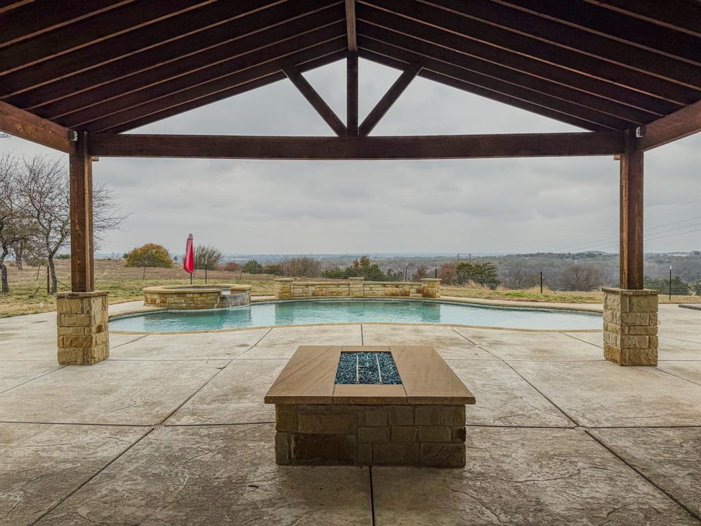 1600 Oak Ridge Estates Weatherford, TX 76085 - Photo 38 of 40 a view of swimming pool with outdoor seating yard and mountain view