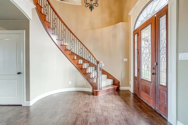 a view of an entryway with wooden floor and stairs