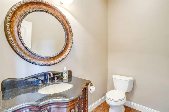 a bathroom with a toilet a sink and a mirror