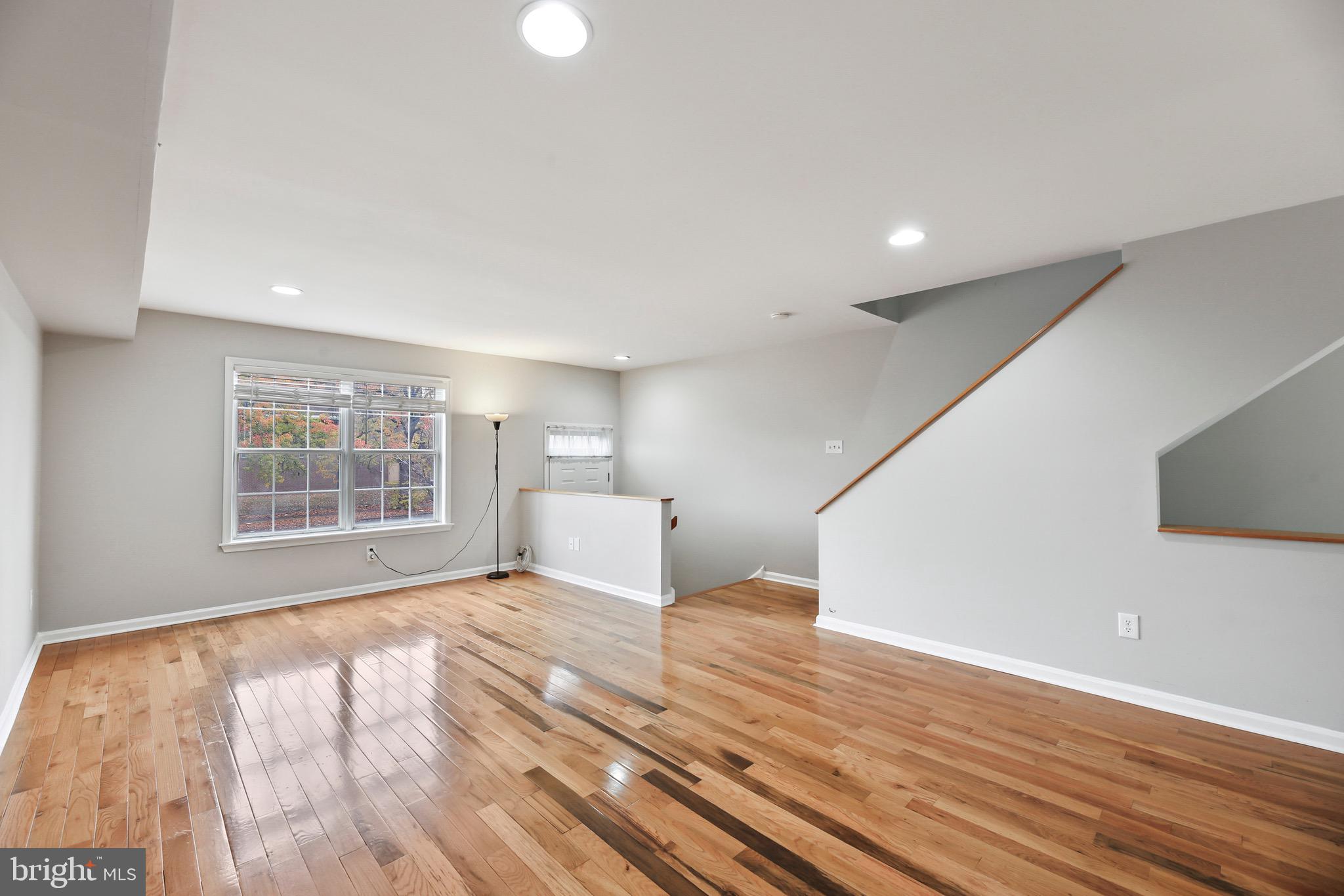 6218 Lindbergh Blvd. Philadelphia, PA 19142 - Photo 3 of 17 a view of empty room with wooden floor and fan