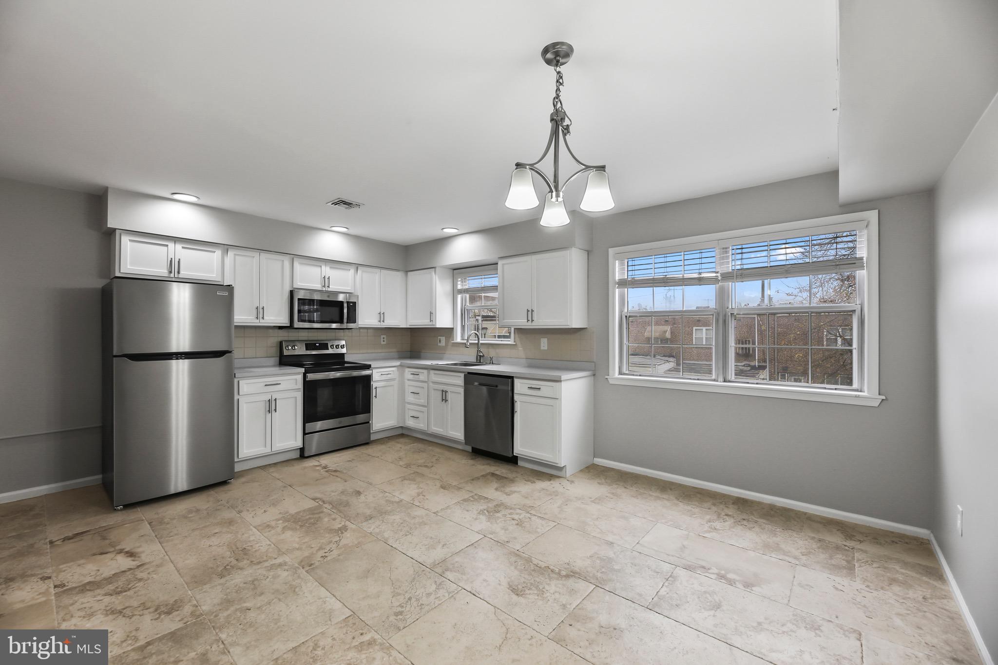 6218 Lindbergh Blvd. Philadelphia, PA 19142 - Photo 4 of 17 a kitchen with stainless steel appliances a refrigerator sink and cabinets