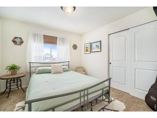 a bedroom with a bed and a table in it
