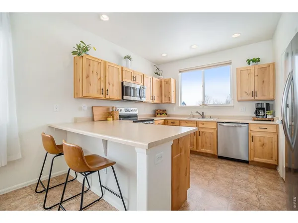 a kitchen with a sink cabinets and window