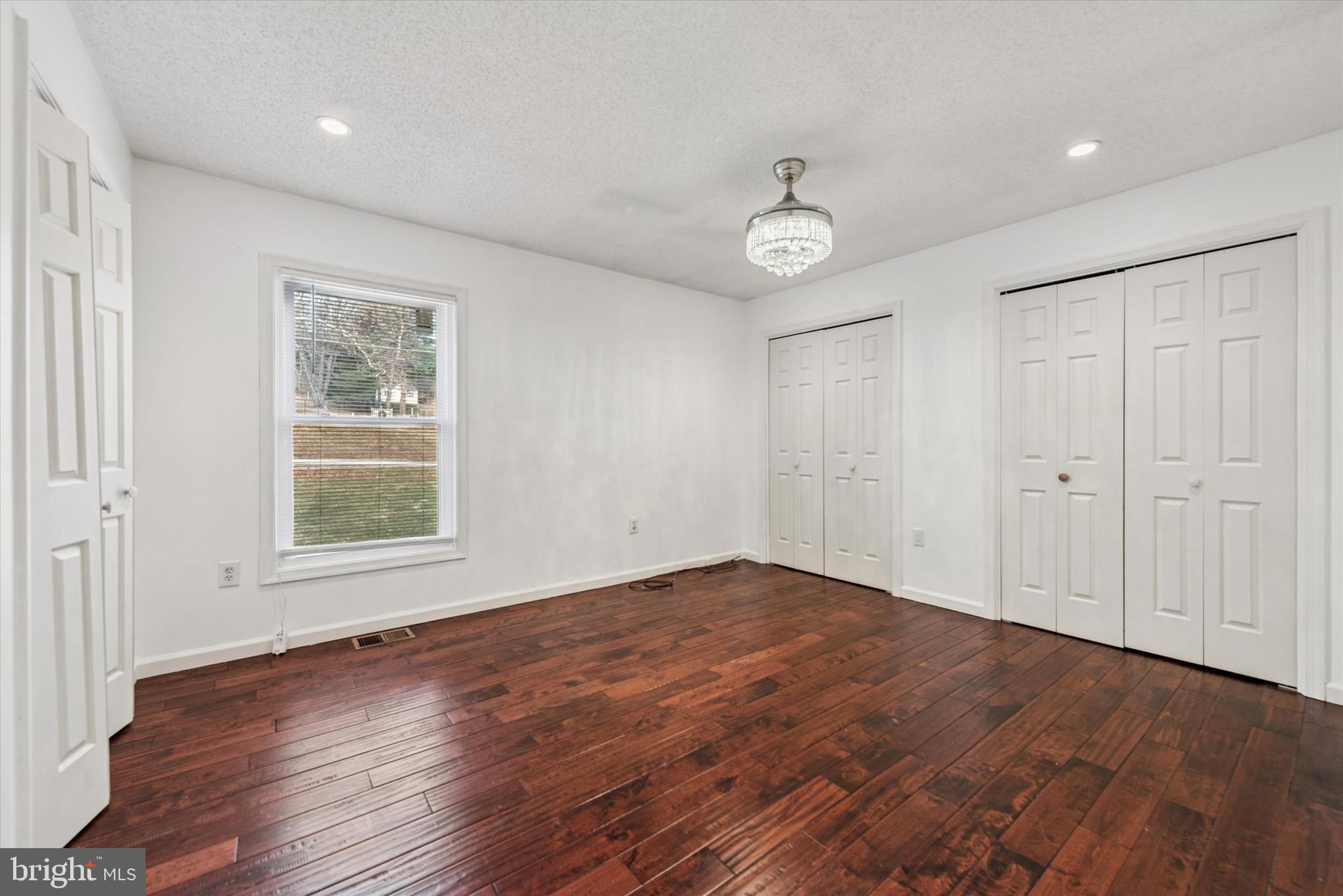 1430 South Bailey Road Coatesville, PA 19320 - Photo 13 of 37 an empty room with wooden floor and windows