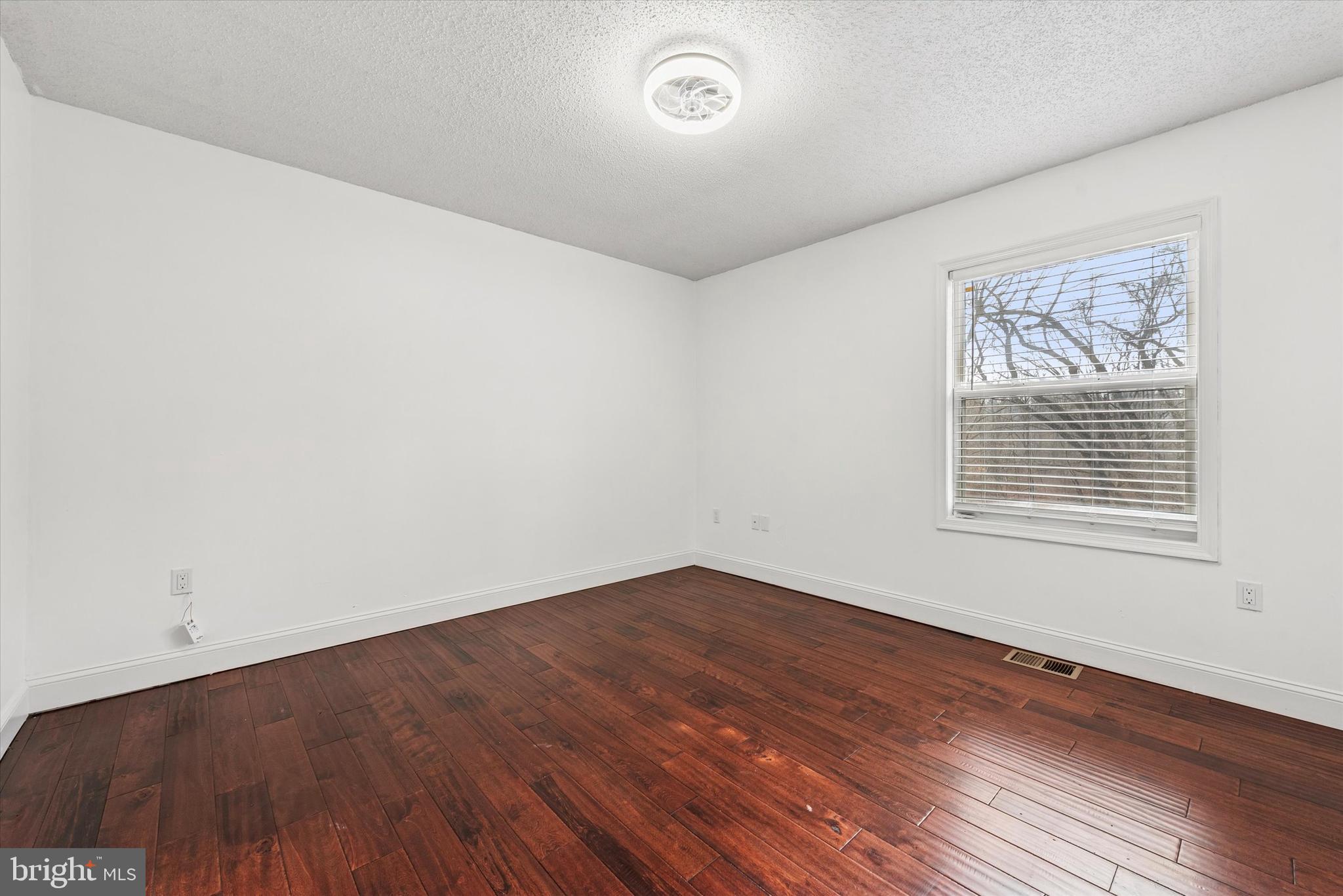 1430 South Bailey Road Coatesville, PA 19320 - Photo 16 of 37 an empty room with wooden floor and windows