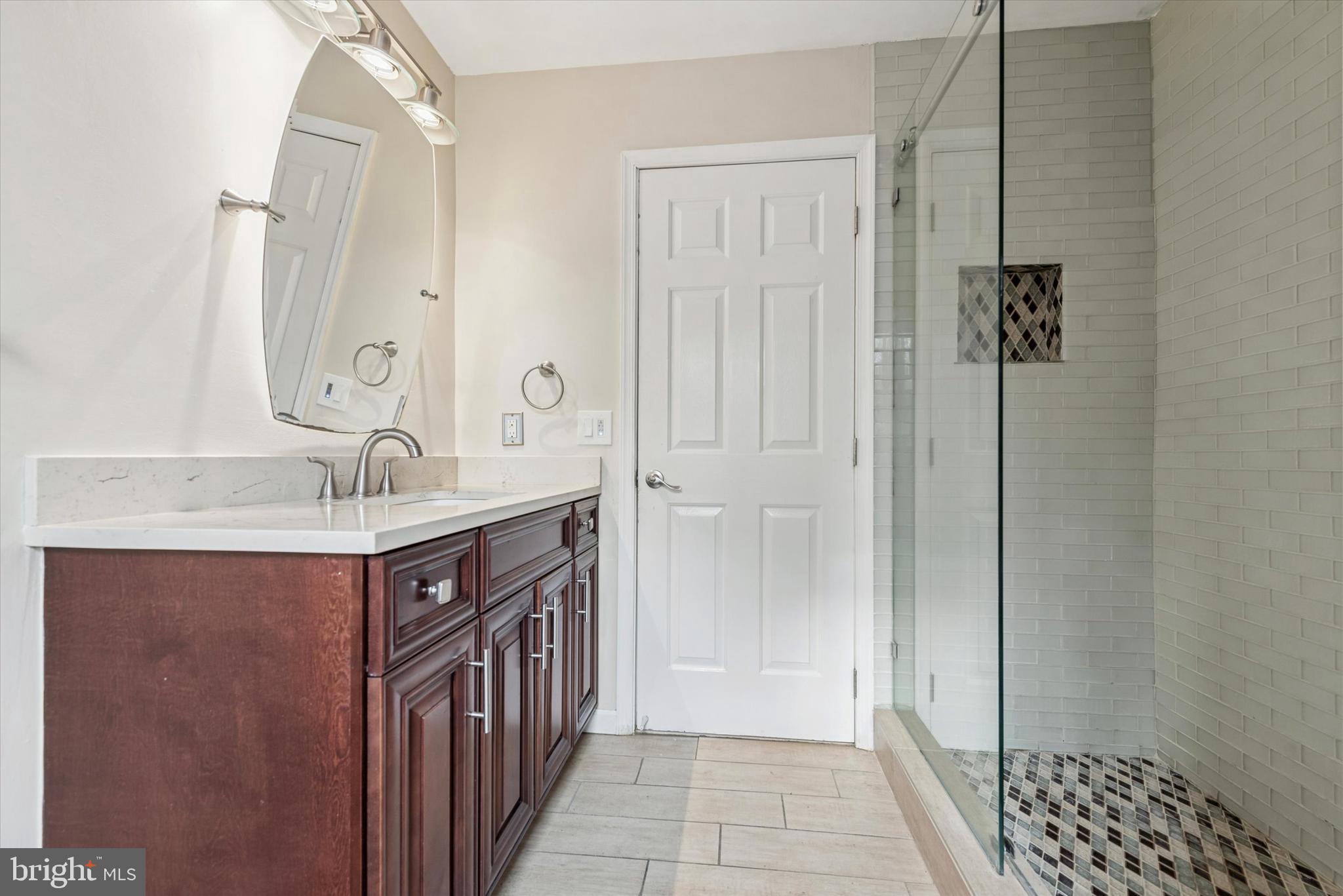 1430 South Bailey Road Coatesville, PA 19320 - Photo 18 of 37 a bathroom with a sink a mirror and a shower