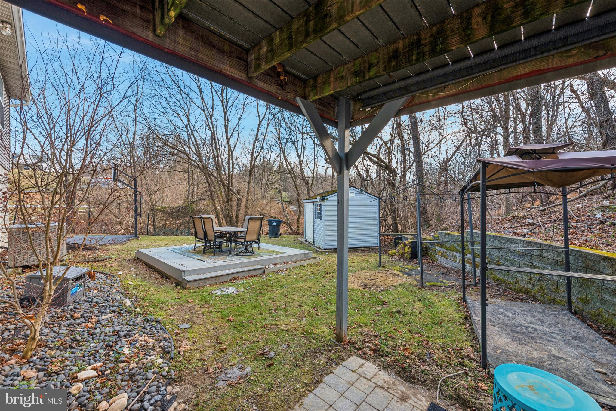 1430 South Bailey Road Coatesville, PA 19320 - Photo 29 of 37 a view of a backyard with table and chairs fire pit and large trees