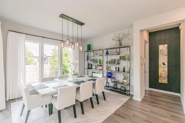 a dining room with furniture and window