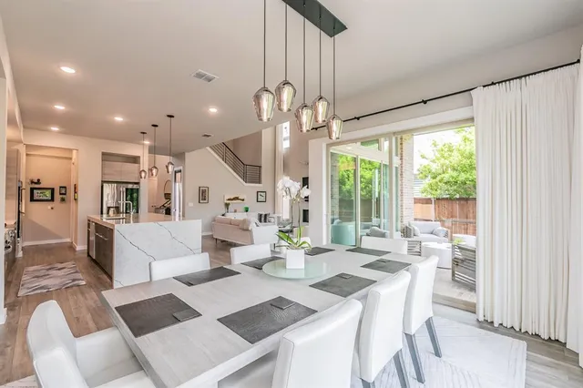 a view of a dining room with furniture wooden floor and chandelier