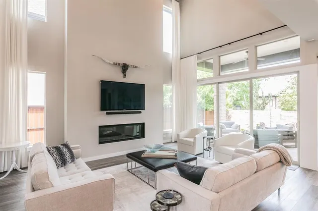 a living room with furniture flat screen tv and a fireplace