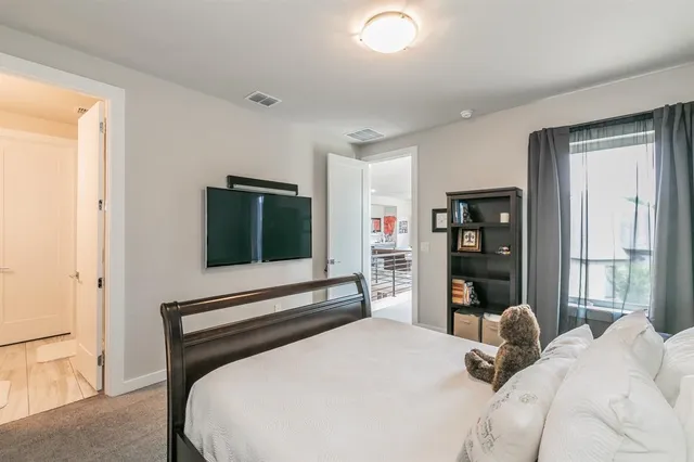 a bedroom with a bed and a large window