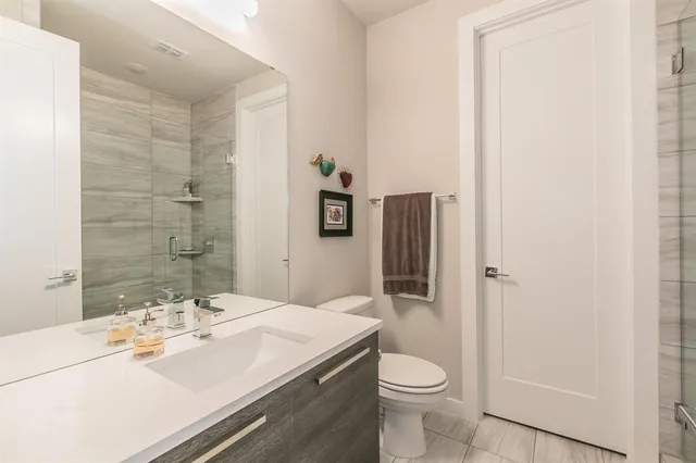 a bathroom with a sink toilet and shower