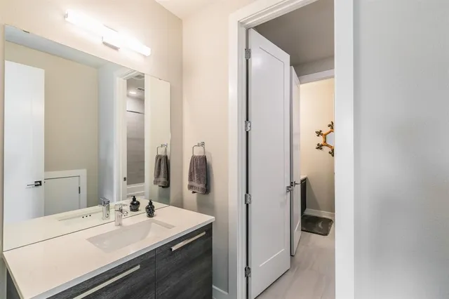 a bathroom with a sink a mirror and a shower