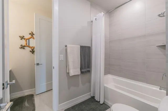 a bathroom with a bathtub and shower