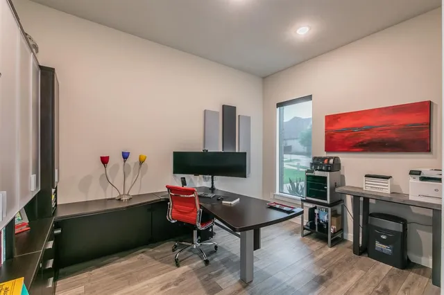 a living room with furniture a flat screen tv and a floor to ceiling window