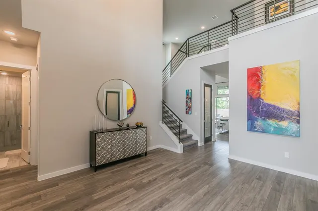 a view of a hallway with wooden floor and entryway