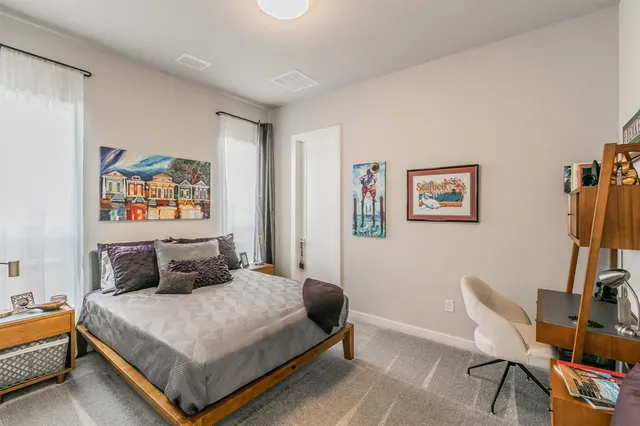 a bedroom with a bed a table and chair