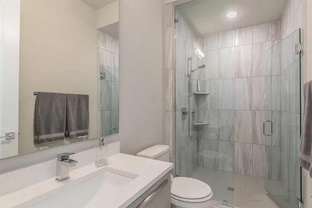 a bathroom with a sink toilet and shower