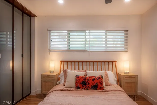 a bed sitting in a bedroom next to a window
