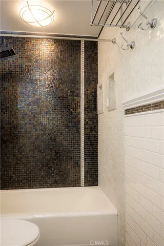 a bathroom with a bathtub and shower