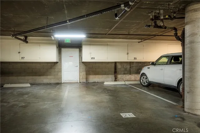 a view of parking garage with cars parked