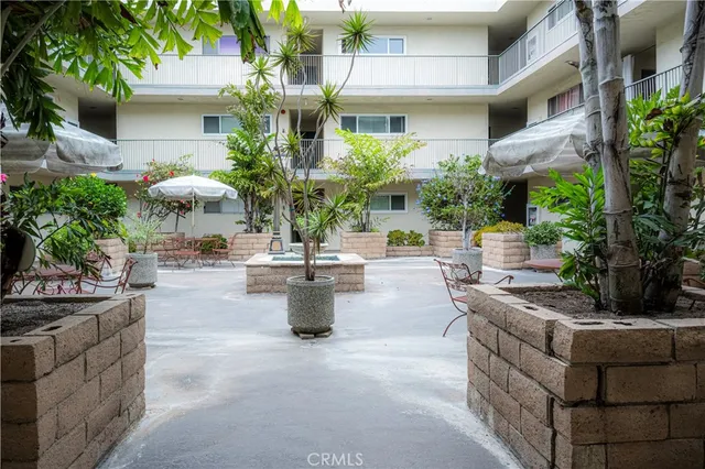 a view of a patio with couches and potted plants